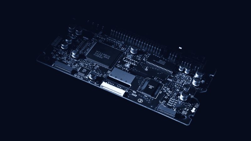 A printed circuit board photographed close up against a dark ground.